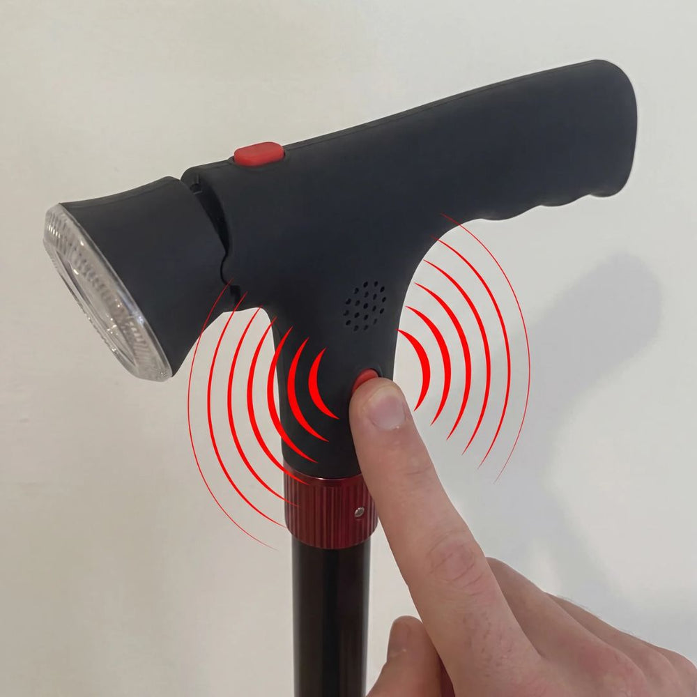 A thumb pressing the built-in alarm button on the StandSecure handle